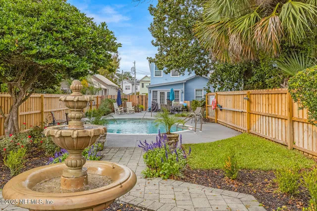 a bedroom with a large bed and a flat tv screen