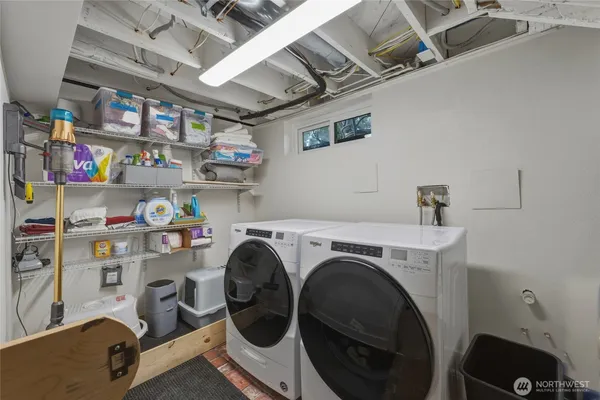a bed room with two chairs and a window