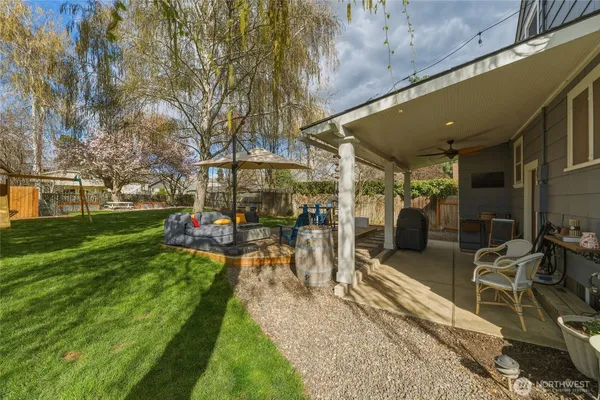 a view of a patio with couches chairs and a umbrella