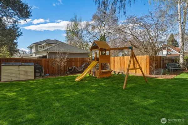 a view of yard with swimming pool and green space