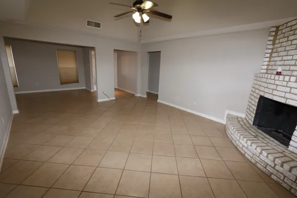 a view of a livingroom with an empty space and a fireplace