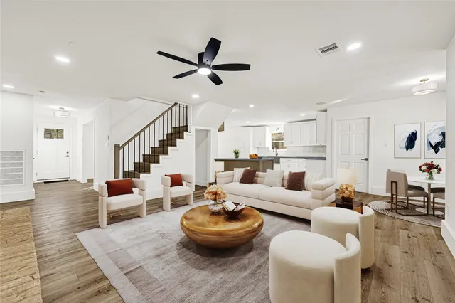 a living room with furniture and a wooden floor