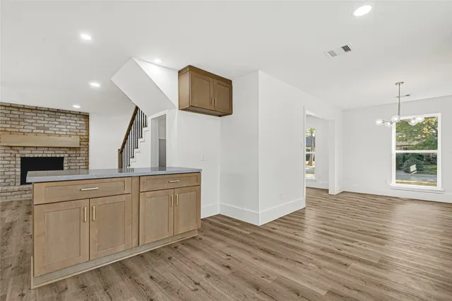 a spacious bathroom with a granite countertop sink and a mirror