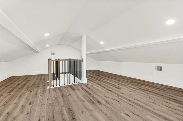 a view of a hallway with wooden floor barbeque oven and chairs