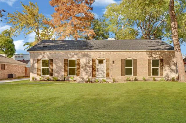a front view of a house with a big yard