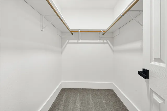 an empty room with closet and ceiling fan