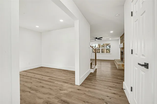 a view of a hallway with wooden floor