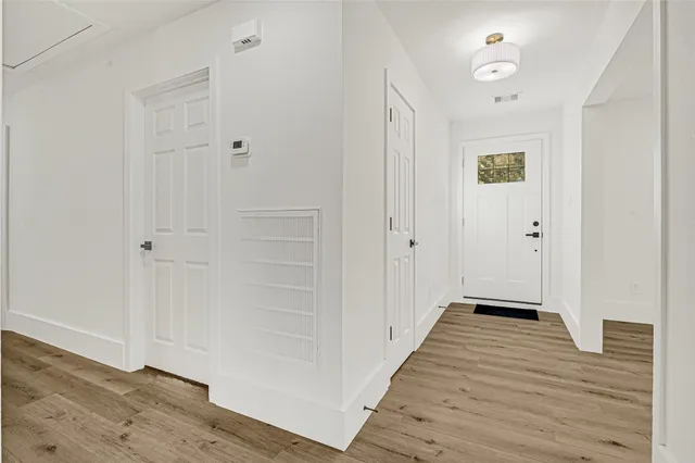 a view of a hallway with wooden floor