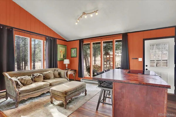 a living room with furniture and large windows