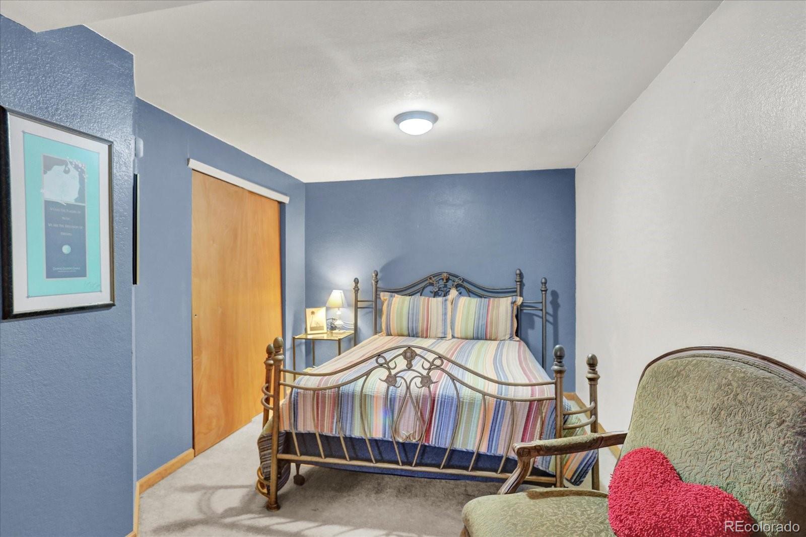 249 Burland Drive Bailey, CO 80421 - Photo 16 of 34 a bedroom with a bed and window