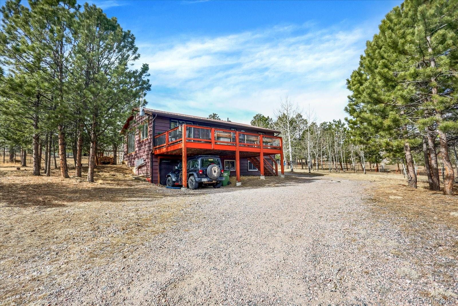 249 Burland Drive Bailey, CO 80421 - Photo 2 of 34 a view of a house with a yard and large tree