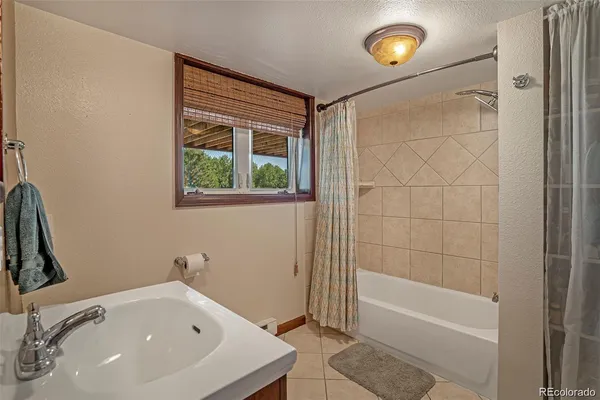 a bathroom with a tub and a sink