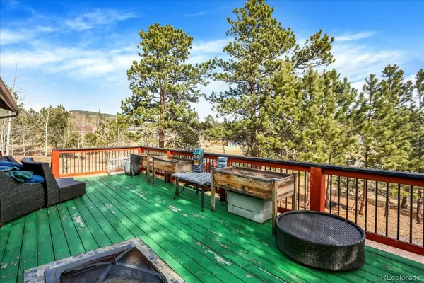 a view of a chairs and table on the wooden deck