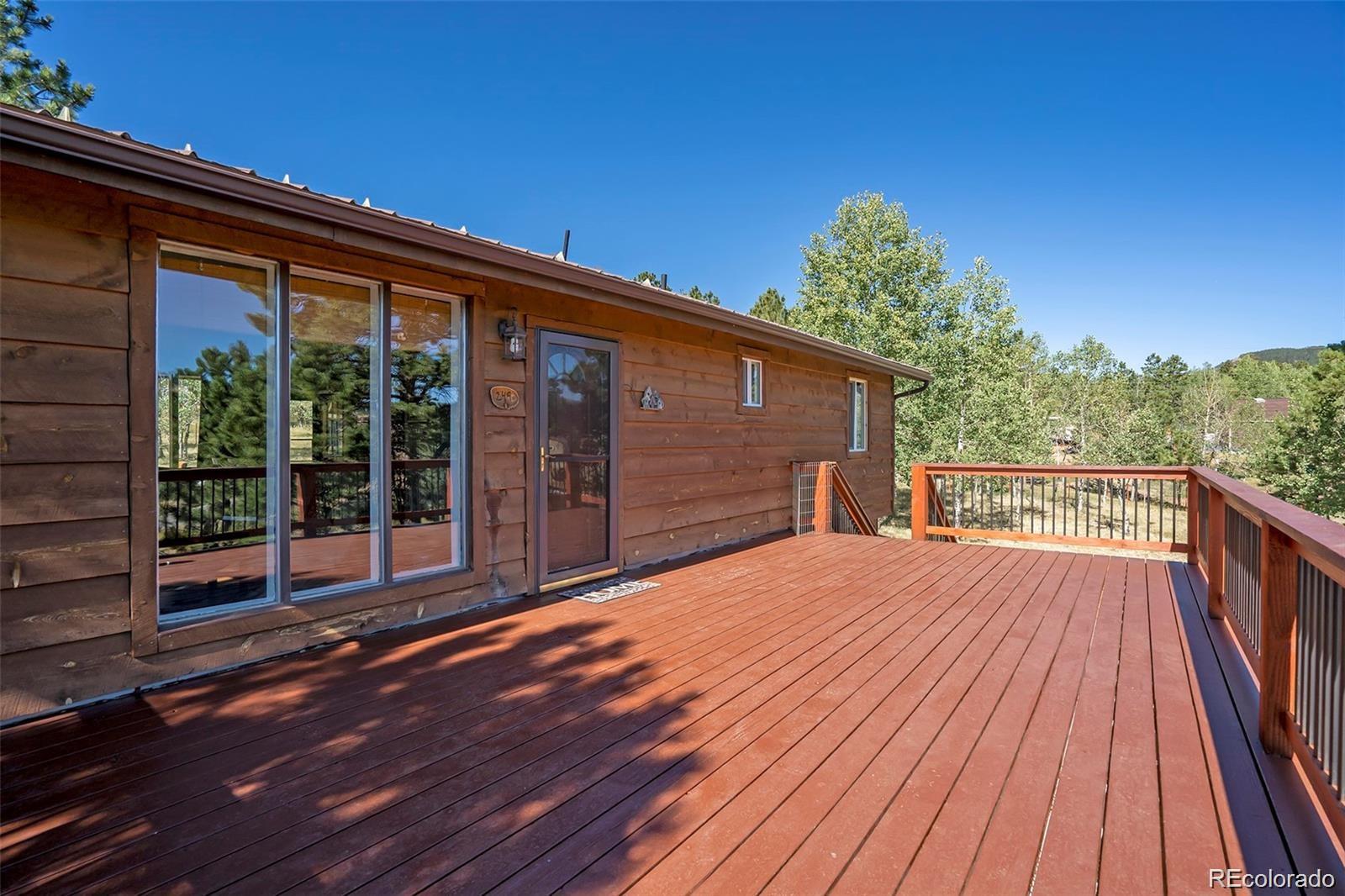 249 Burland Drive Bailey, CO 80421 - Photo 26 of 34 a balcony with wooden floor and city view