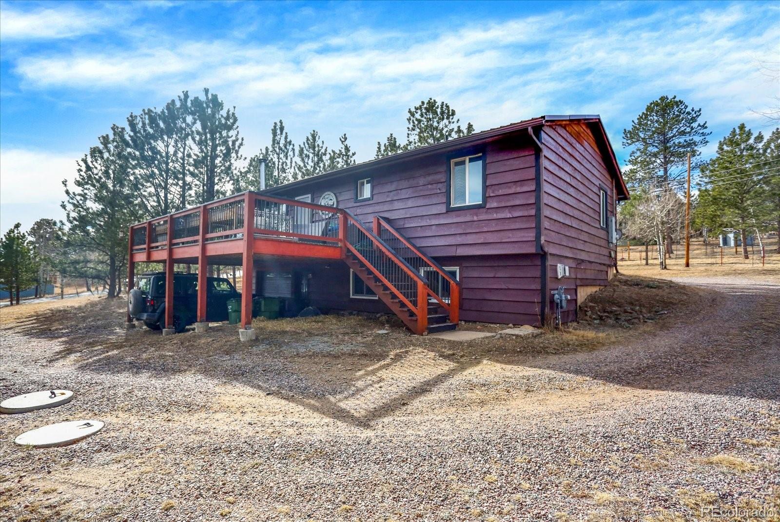 249 Burland Drive Bailey, CO 80421 - Photo 28 of 34 a view of a house with a yard