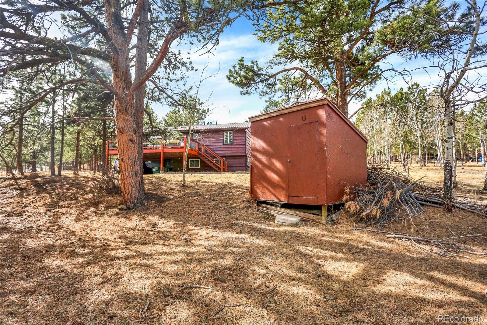 249 Burland Drive Bailey, CO 80421 - Photo 29 of 34 a backyard of a house with table and chairs