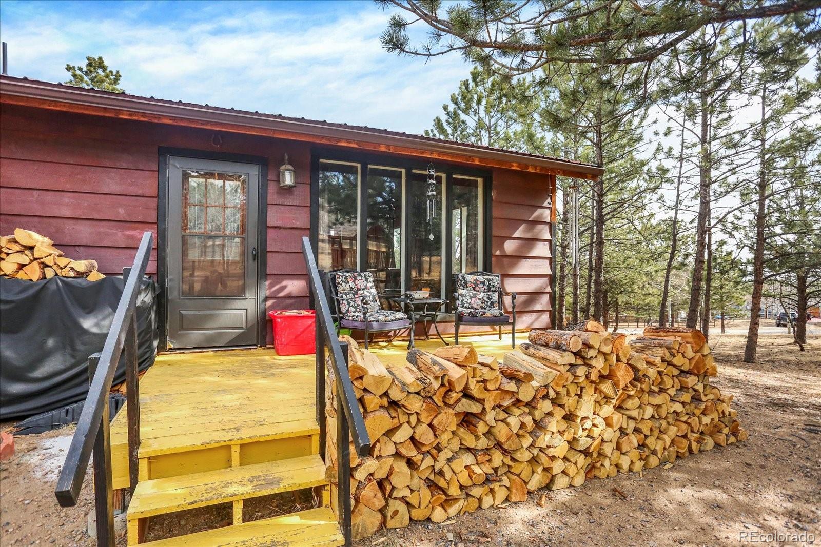 249 Burland Drive Bailey, CO 80421 - Photo 3 of 34 a front view of house with outdoor seating