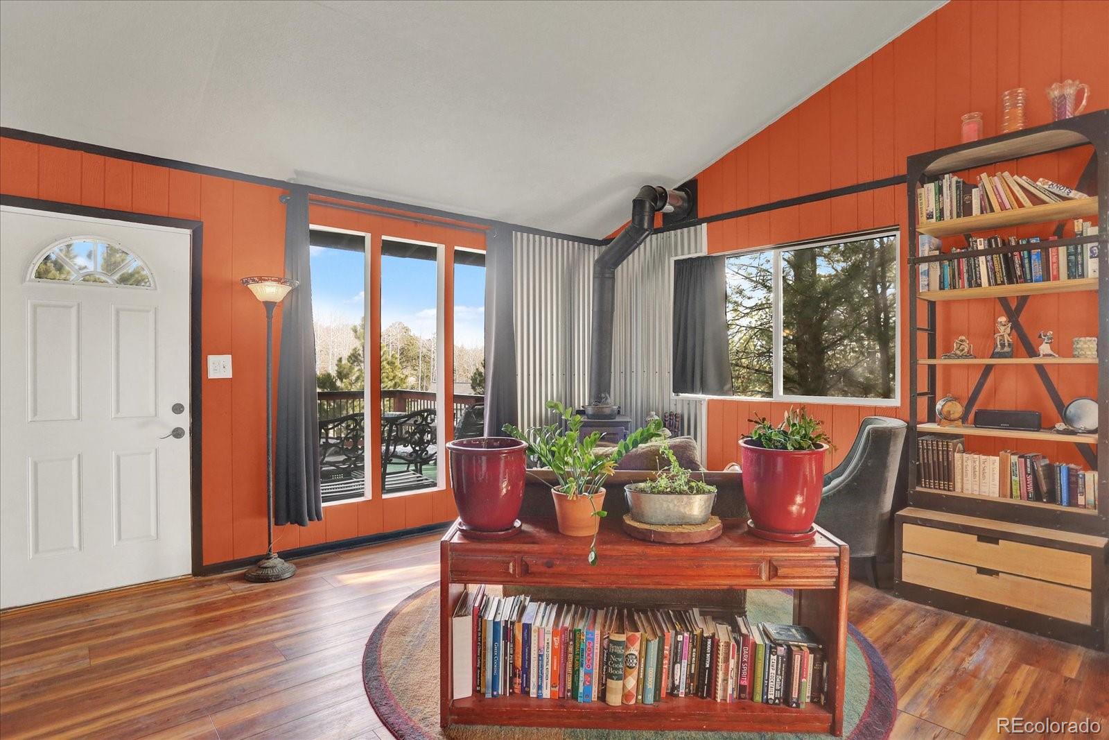 249 Burland Drive Bailey, CO 80421 - Photo 9 of 34 a dining room with furniture window and wooden floor