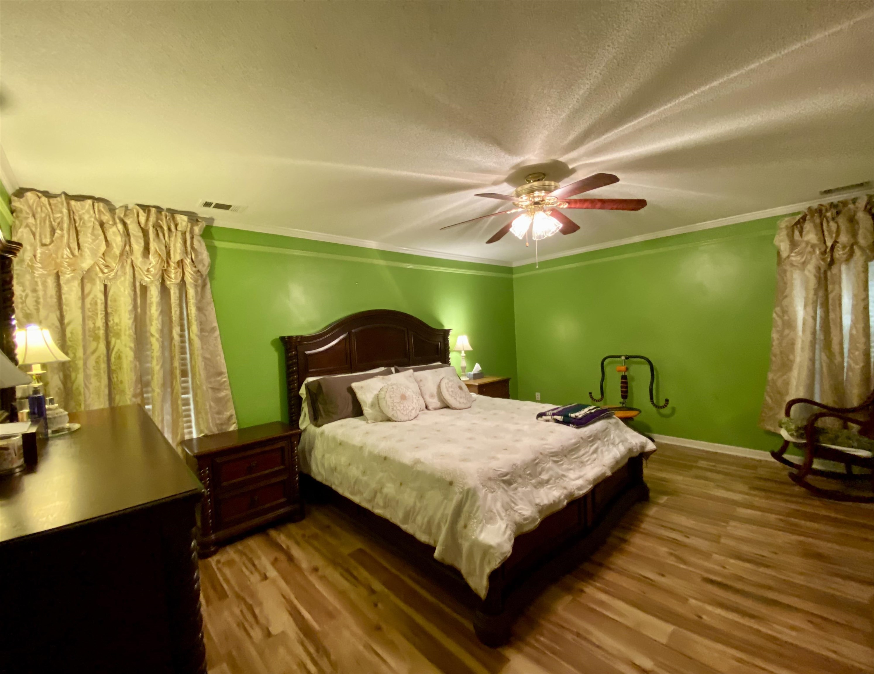 1235 Creeks Edge Cove Memphis, TN 38016 - Photo 12 of 15 Primary Bedroom featuring dark wood-type flooring, crown molding, a textured ceiling, and a ceiling fan