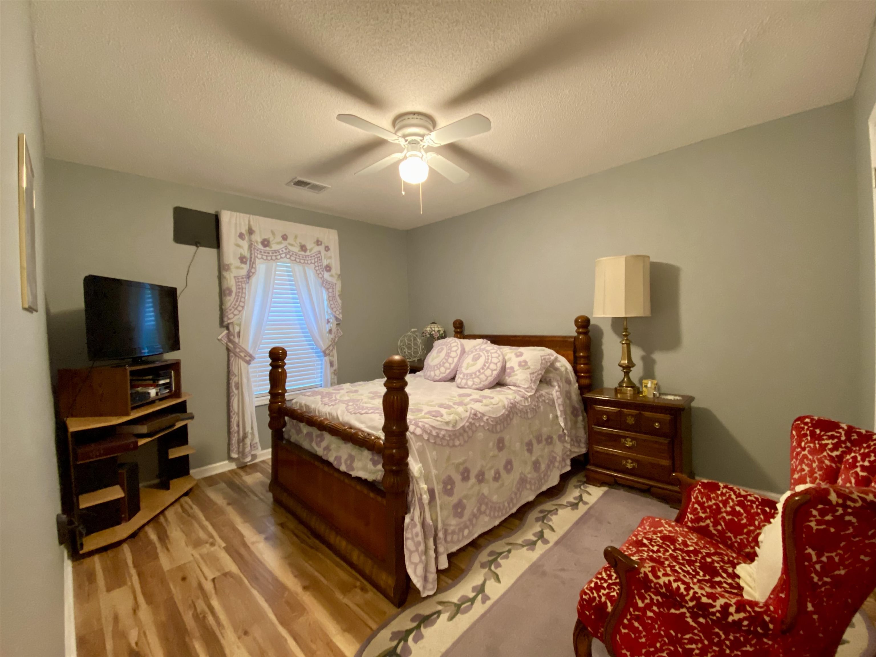 1235 Creeks Edge Cove Memphis, TN 38016 - Photo 5 of 15 Bedroom featuring light wood-style floors, a textured ceiling, and ceiling fan