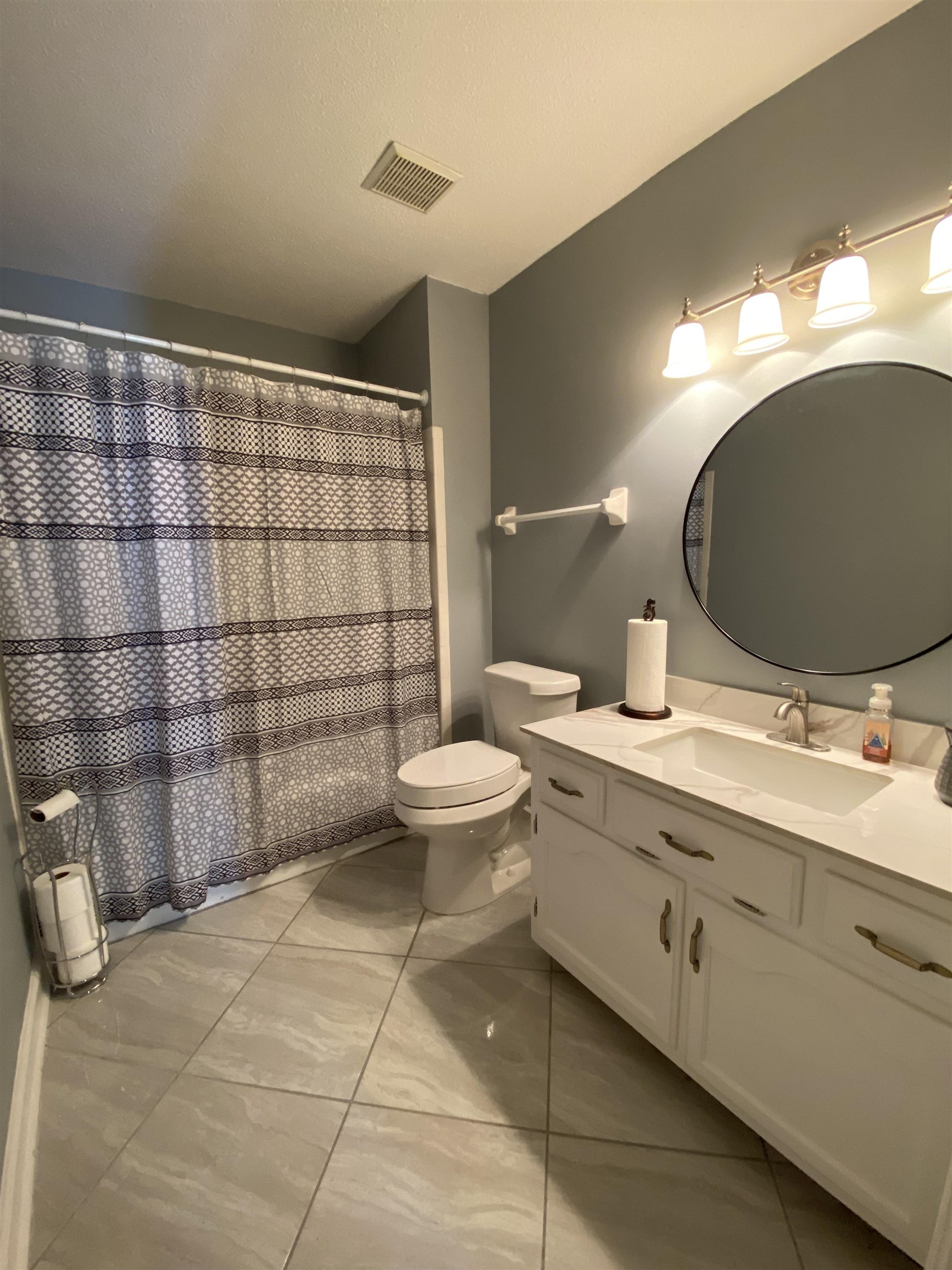 1235 Creeks Edge Cove Memphis, TN 38016 - Photo 6 of 15 Full bath featuring vanity, curtained shower, light tile patterned floors, and a textured ceiling