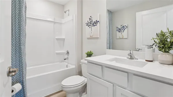 a bathroom with a granite countertop sink a toilet and a bathtub