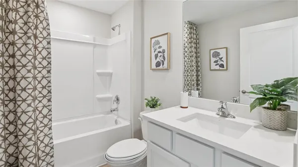 a bathroom with a sink a toilet a tub and shower