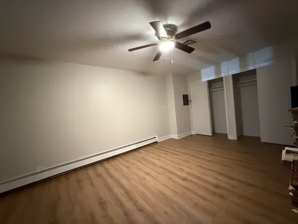 a view of a room with wooden floor
