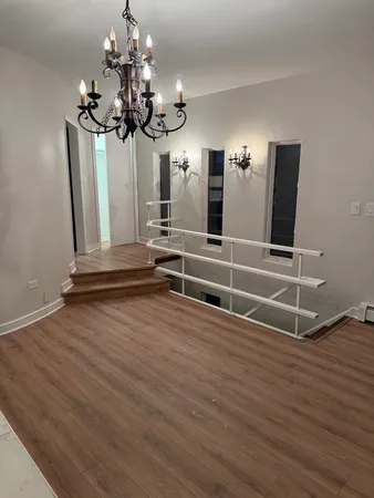 a view of a room with wooden floor