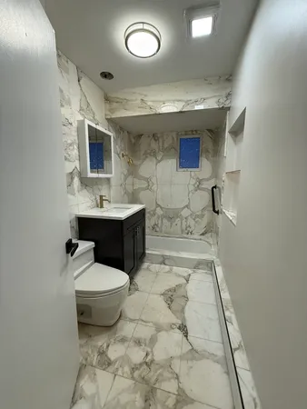 a view of a room with wooden floor and chandelier