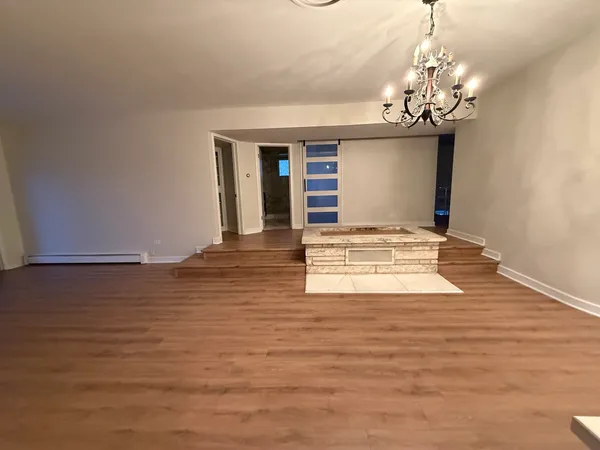 a view of a room with wooden floor and window