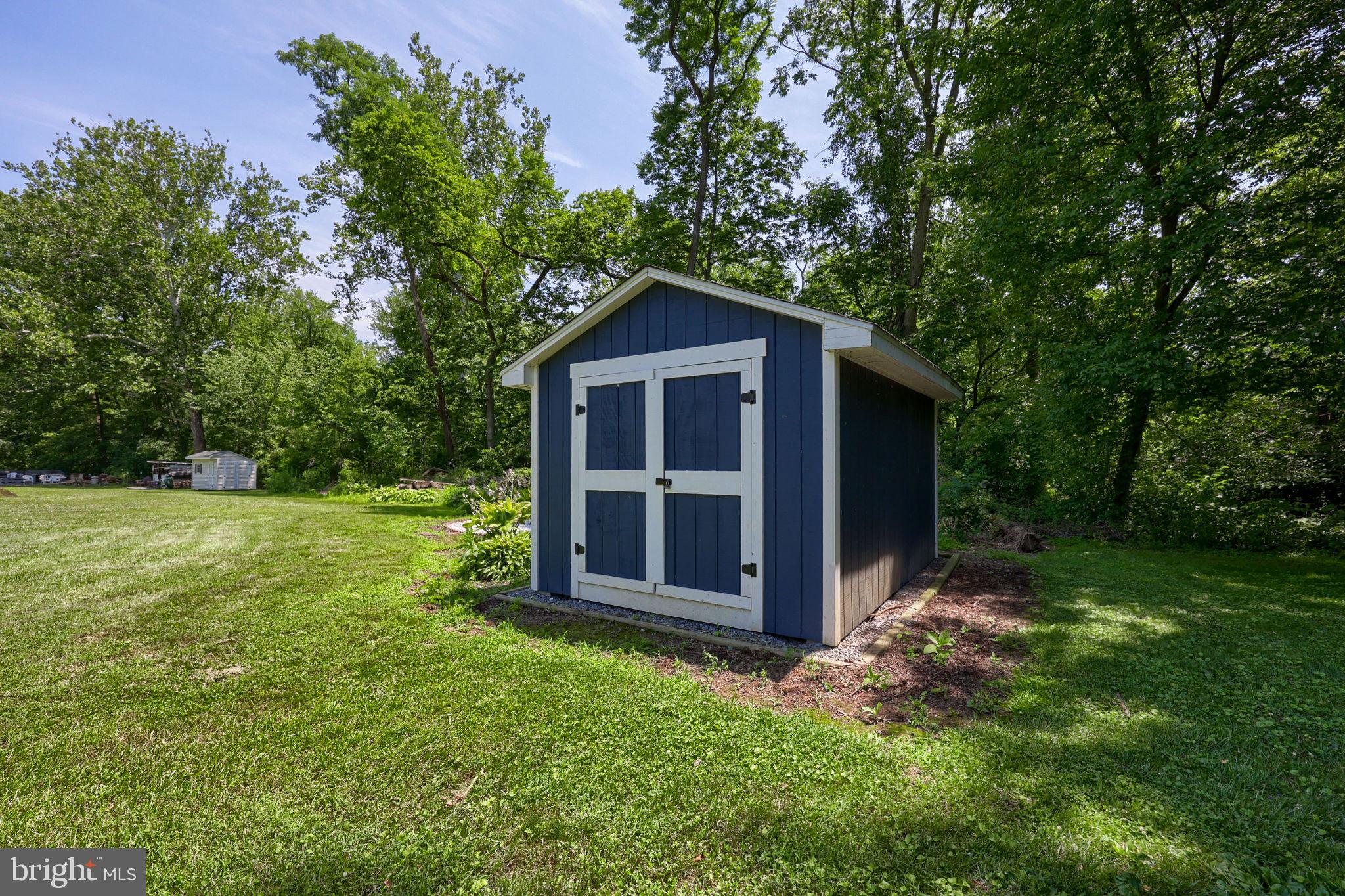 3356 Turnpike Road Elizabethtown, PA 17022 - Photo 49 of 52 Charming shed nestled in lush greenery.