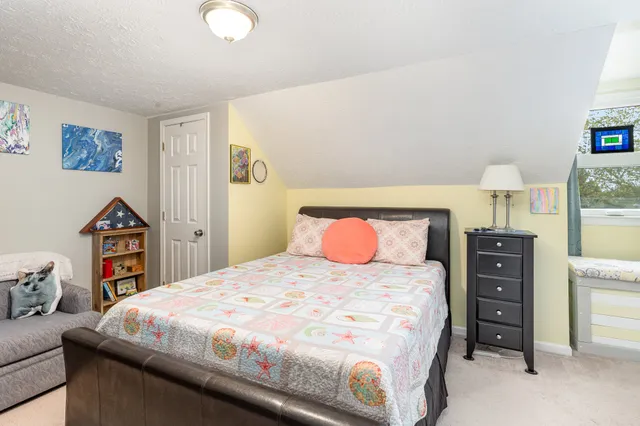 a bedroom with a bed and flat screen tv