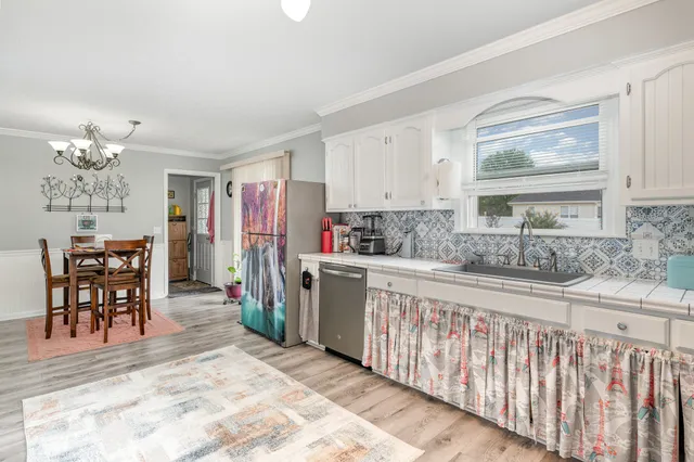 a kitchen with stainless steel appliances granite countertop a refrigerator and a stove top oven