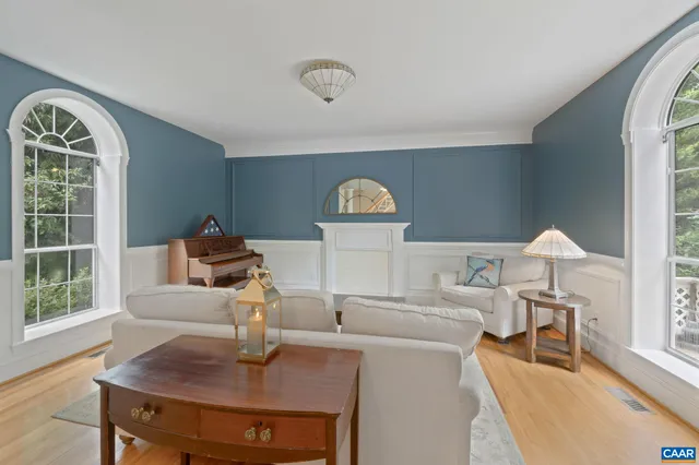 a kitchen with stainless steel appliances granite countertop a stove a sink dishwasher and white cabinets with wooden floor