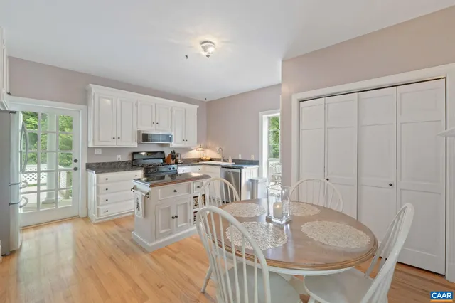 a kitchen with granite countertop a sink stove and refrigerator