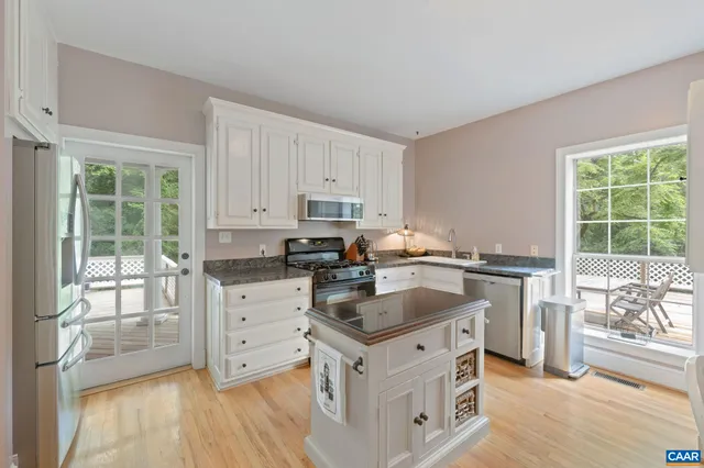a dining room with furniture and a window