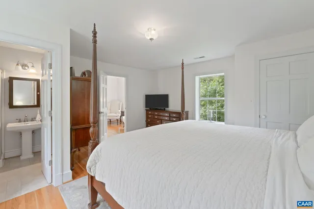 a living room with furniture a flat screen tv and a window