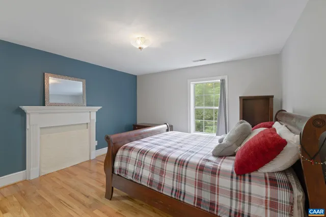a roof deck with a table and chairs and wooden floor
