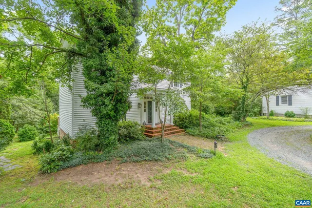a view of a big yard with plants and a garden