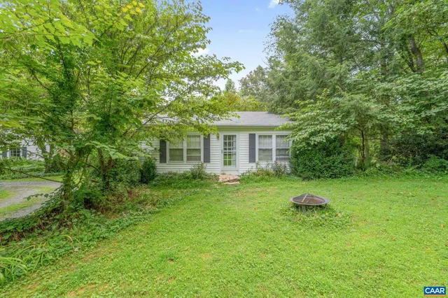 a view of a big yard with large trees