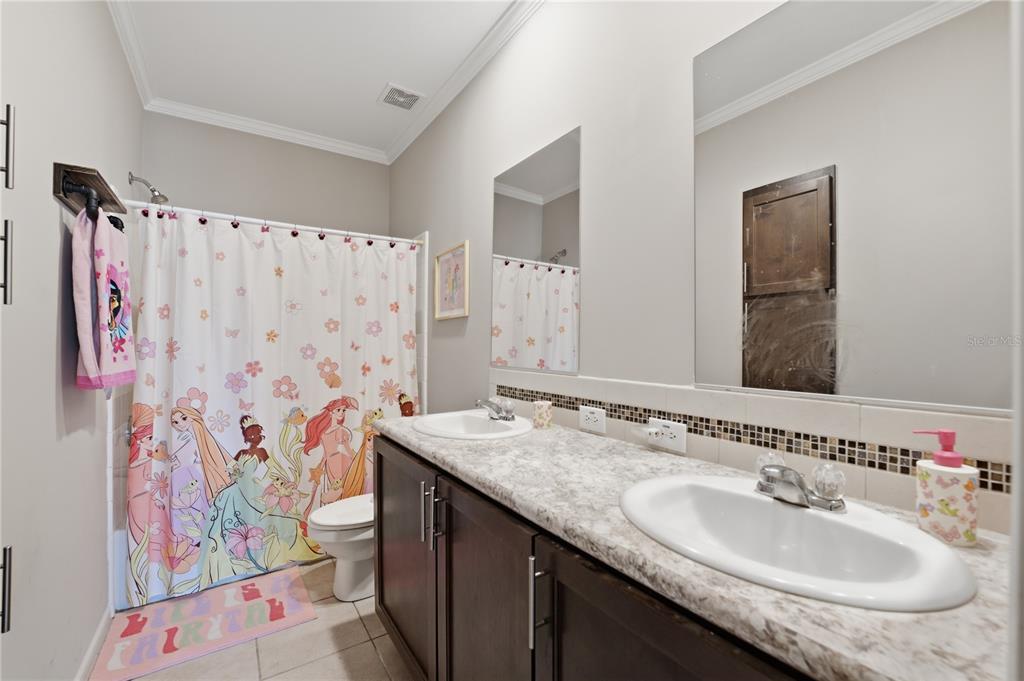 6844 Chad Jason Road St. Cloud, FL 34773 - Photo 24 of 59 a bathroom with a sink and a mirror