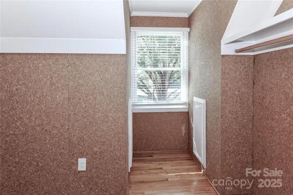 a view of a room with wooden floor