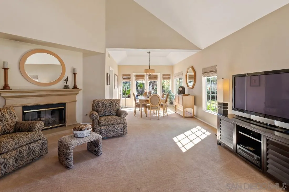 13755 Royal Melbourne Square San Diego, CA 92128 - Photo 11 of 75 a living room with furniture a fireplace and a large window
