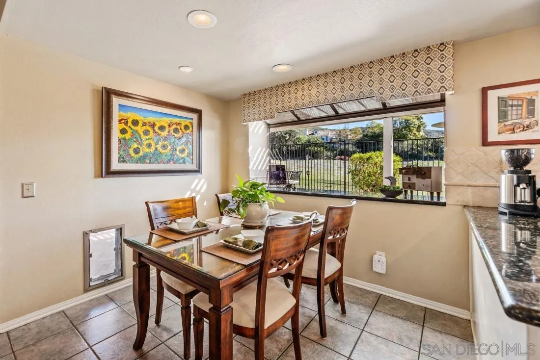 13755 Royal Melbourne Square San Diego, CA 92128 - Photo 21 of 75 a view of a dining room with furniture large windows and wooden floor