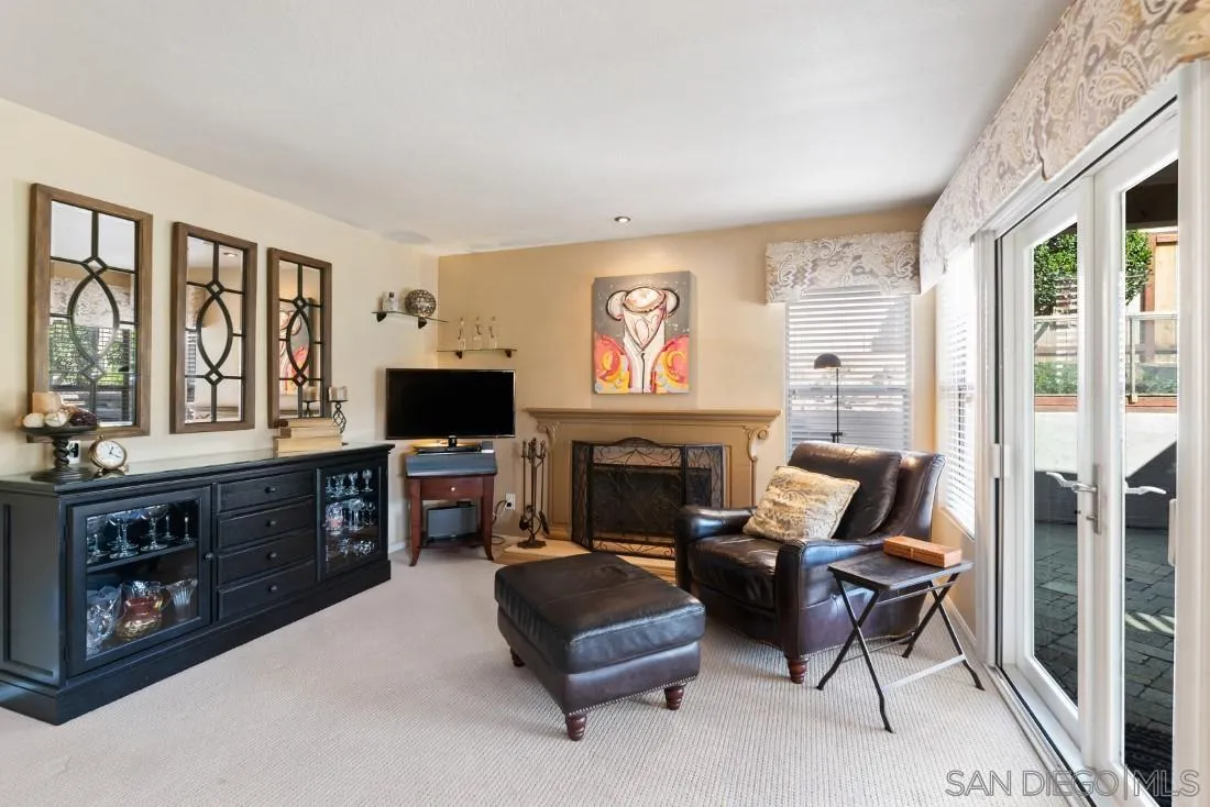 13755 Royal Melbourne Square San Diego, CA 92128 - Photo 22 of 75 a living room with furniture fireplace and flat screen tv