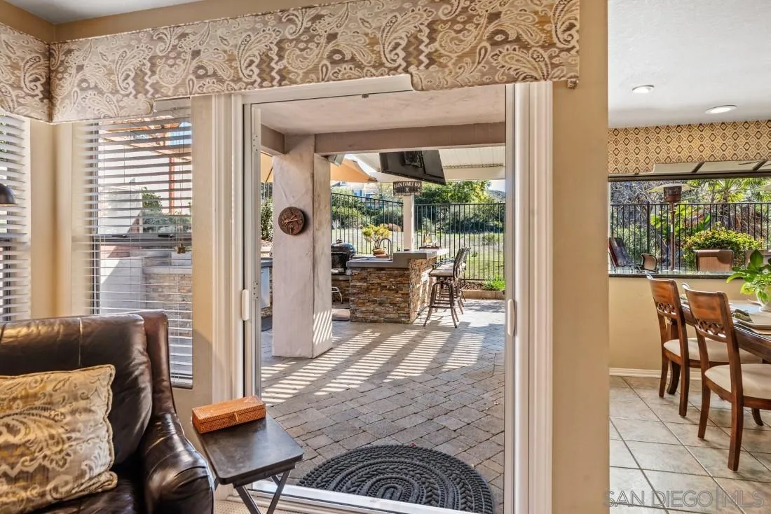13755 Royal Melbourne Square San Diego, CA 92128 - Photo 24 of 75 a living room with furniture and a floor to ceiling window