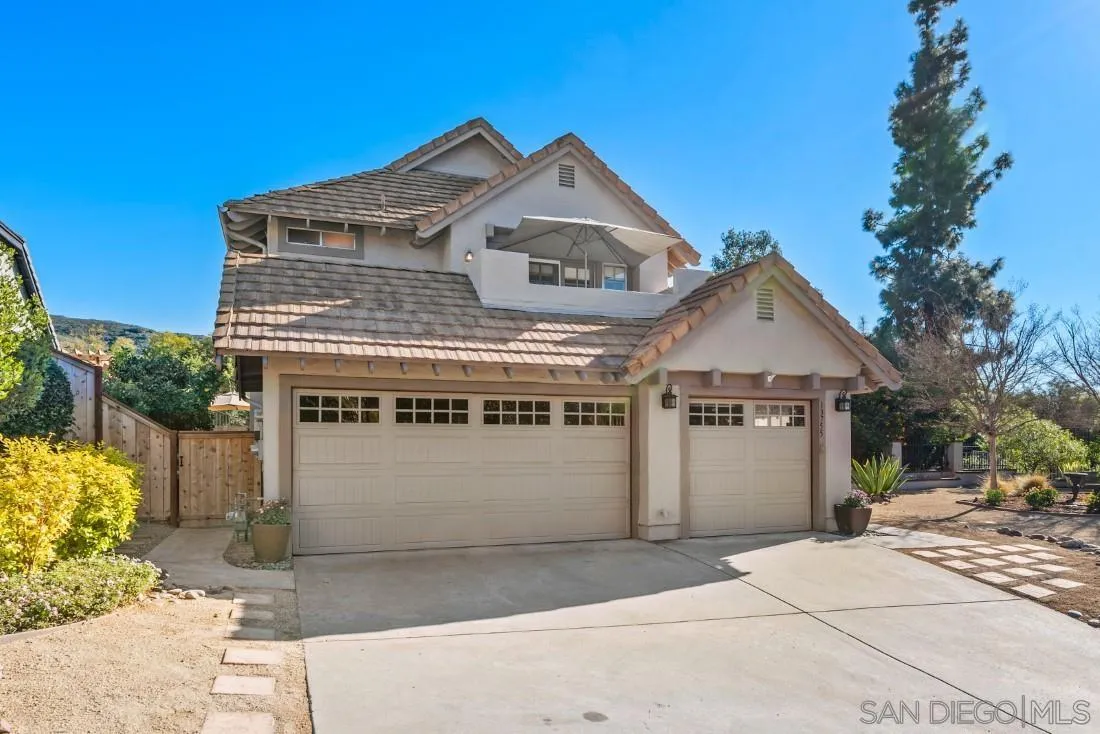 13755 Royal Melbourne Square San Diego, CA 92128 - Photo 3 of 75 a front view of a house with a yard