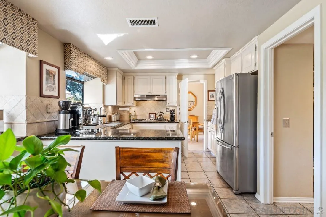 13755 Royal Melbourne Square San Diego, CA 92128 - Photo 37 of 75 a kitchen with stainless steel appliances granite countertop a refrigerator and a stove