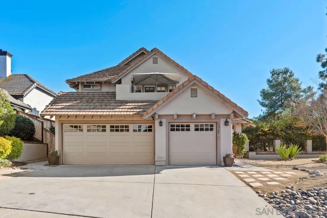 13755 Royal Melbourne Square San Diego, CA 92128 - Photo 5 of 75 a front view of a house with a garage